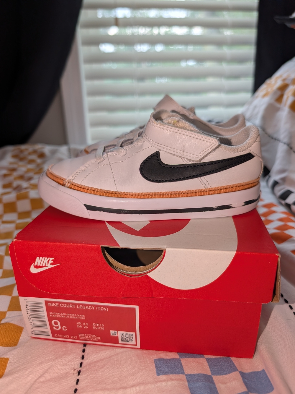 Nike Kids White Sneaker with Black Swoosh and Orange Trim